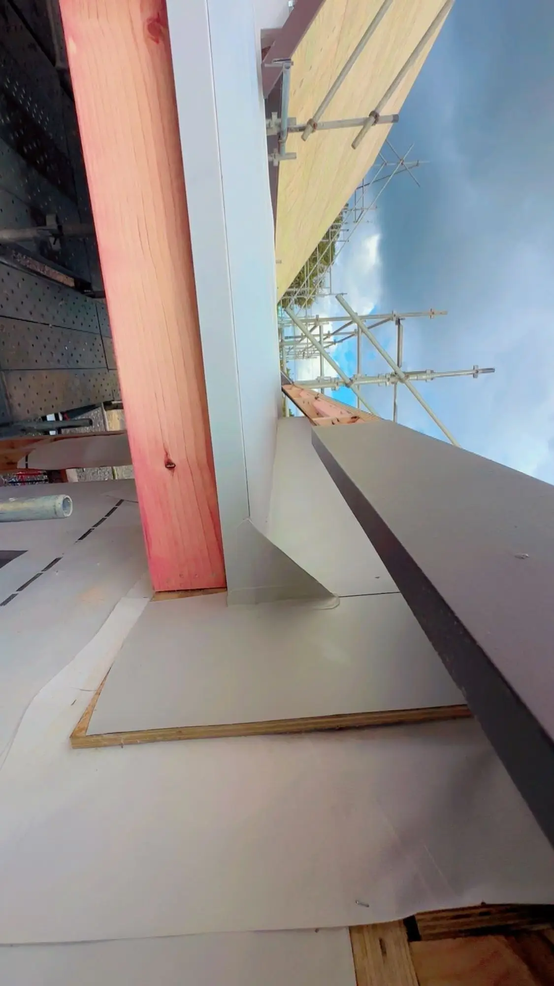 Apron flashing installed against timber framing on a metal roof