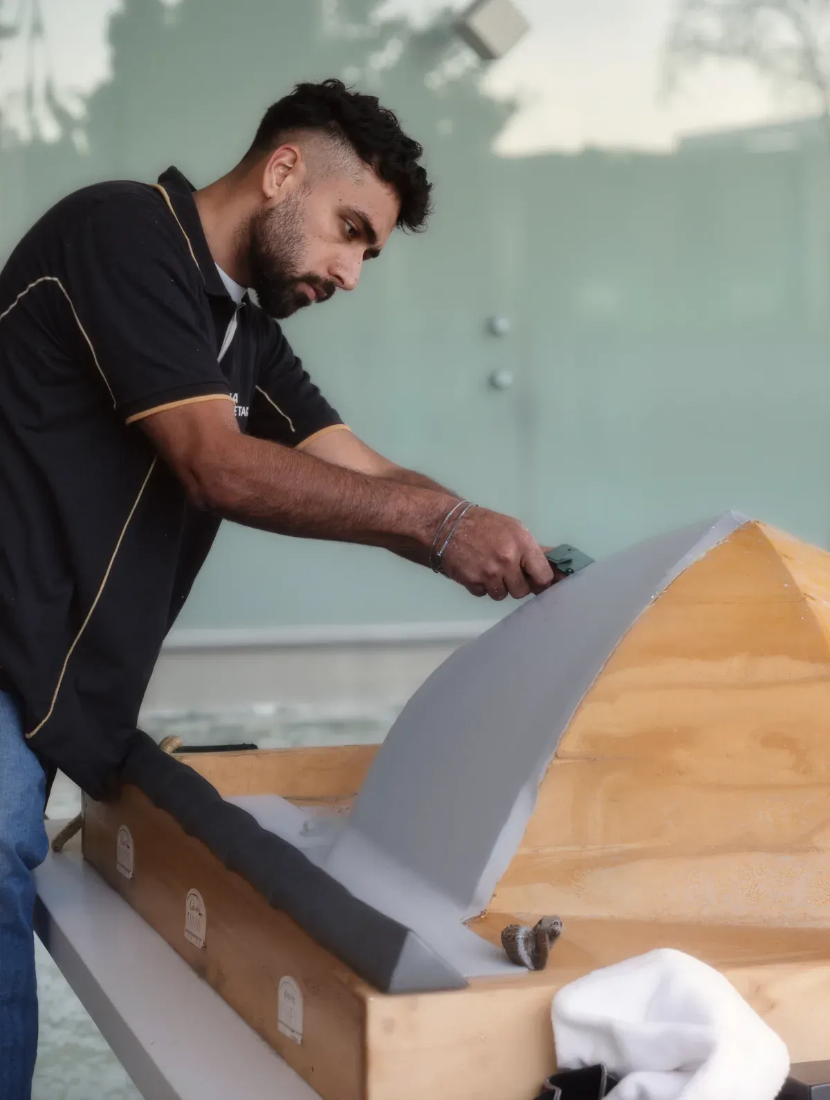 Harvinder Banga shaping a curved flashing on site in Auckland
