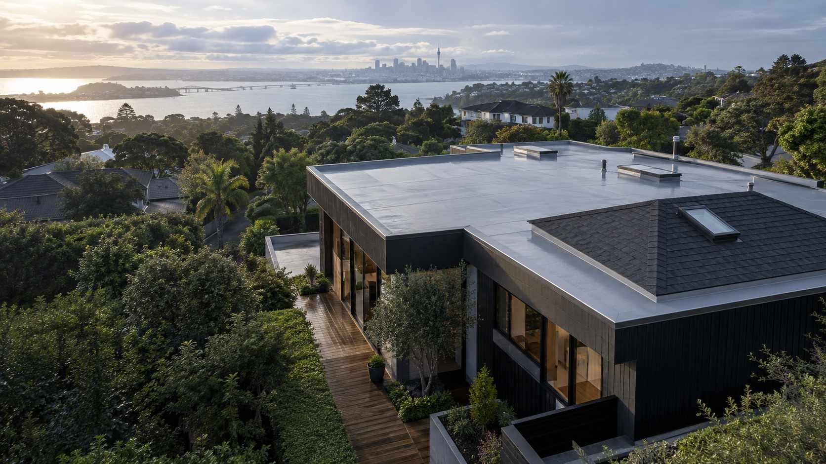 Completed membrane and asphalt shingle roofs on a modern Auckland home
