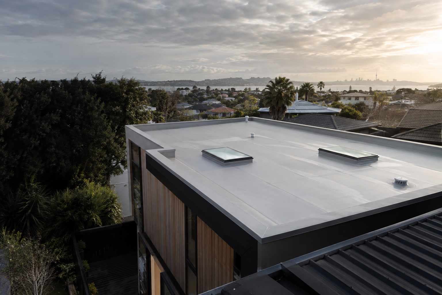 Completed light grey membrane roof on a modern Auckland home