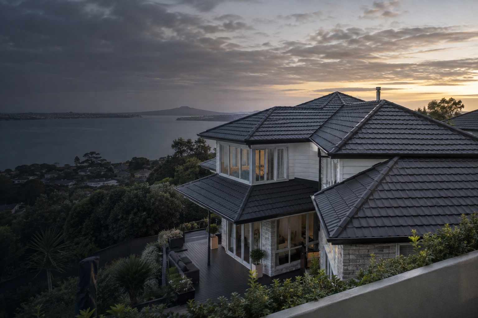 Completed charcoal pressed metal tile roof on an Auckland home