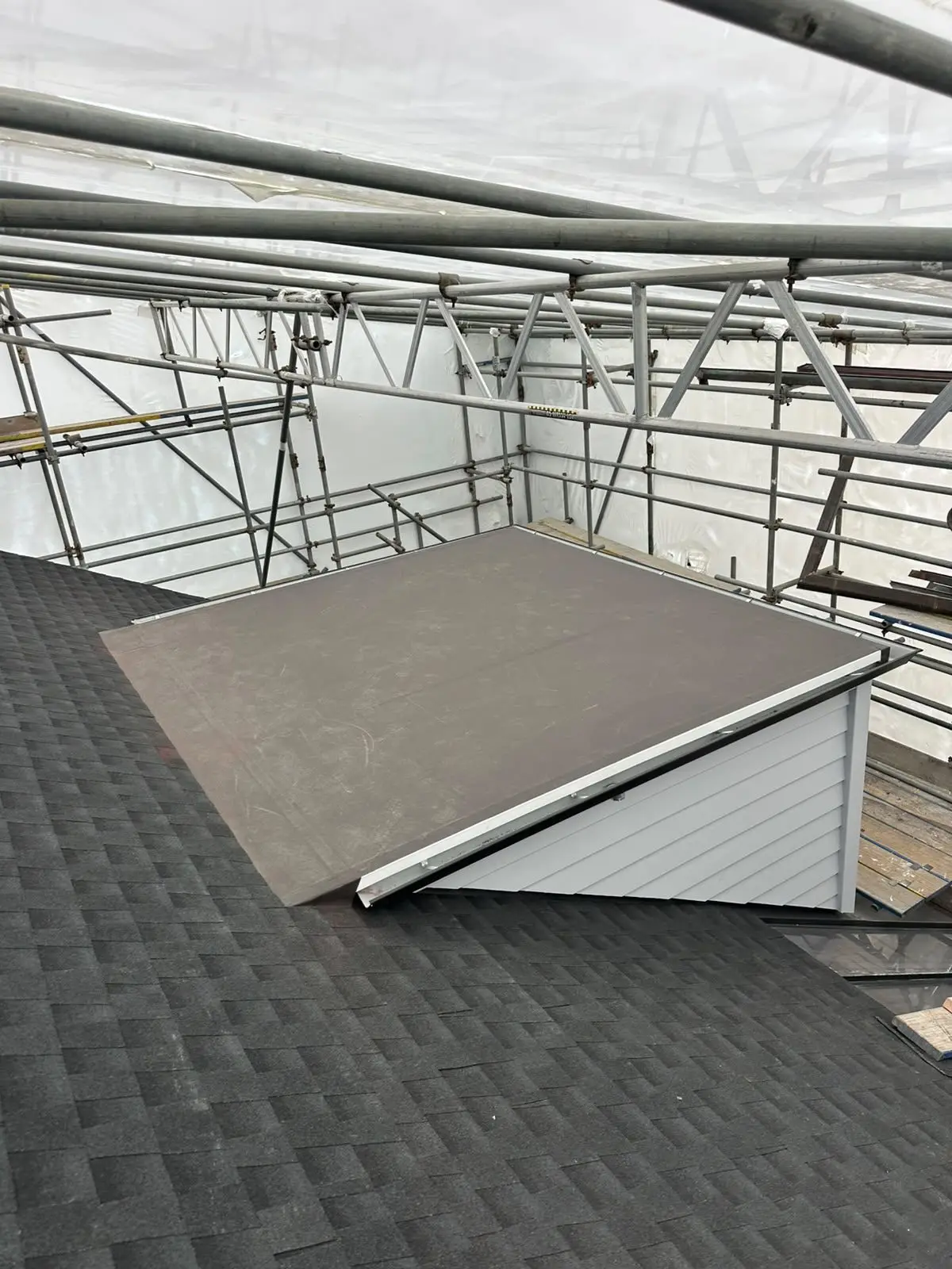 Flat dormer flashed into an asphalt shingle roof