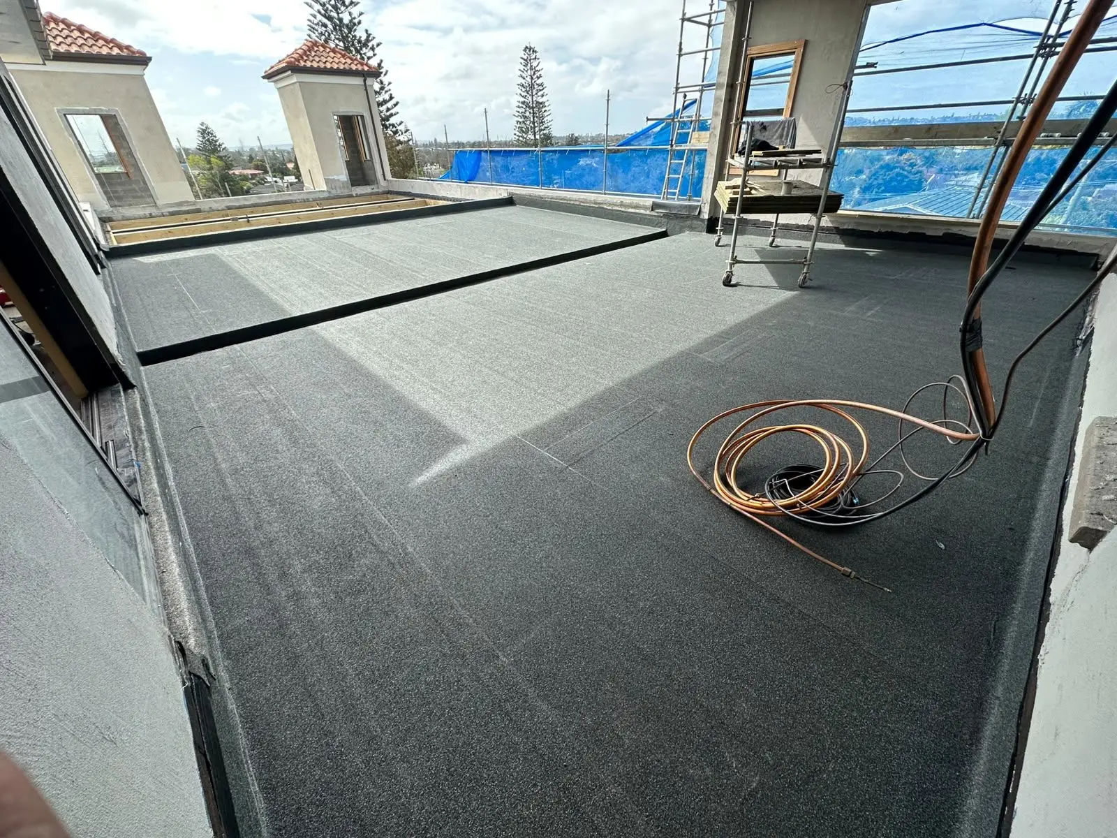 Torch-on membrane roof with skylights installed on an Auckland building